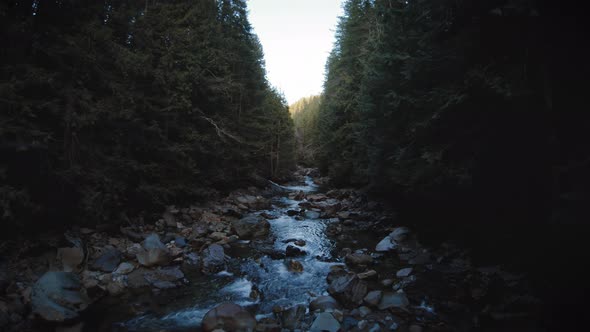 Drone Flying Up River Hallway With Peaceful Water Flow