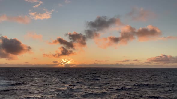 Stunning colorful sunset over ocean horizon with no land, nobody