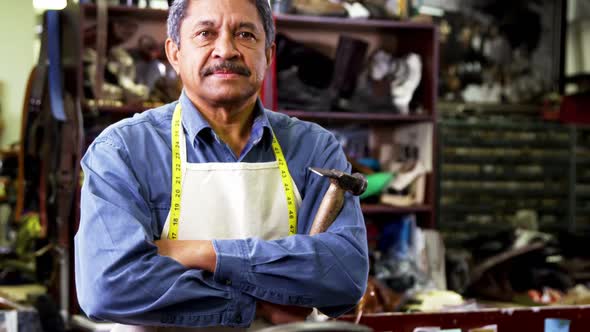 Portrait of shoemaker standing with arms crossed