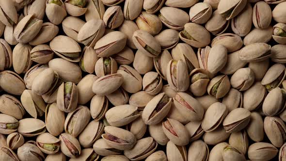 salt pistachios nuts top view rotation. Pistachio nuts in the peel. Whole nut kernels