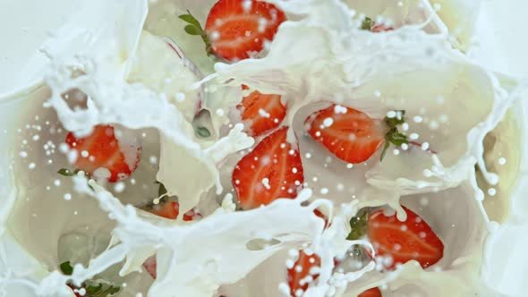Super Slow Motion Shot of Fresh Strawberries Falling Into Milk at 1000Fps