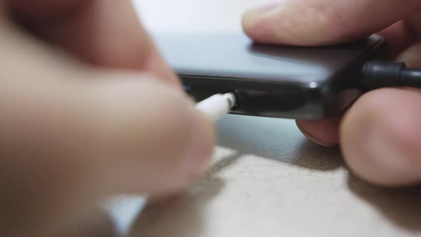 Caucasian Male Hand is Plugging and Unplugging Headphone Jack