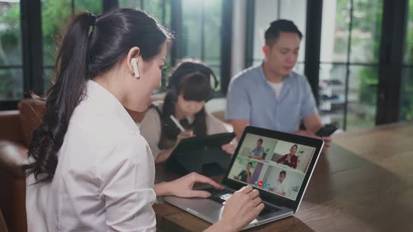 Asian group of business woman and man talk to colleague team in video conference with family at home