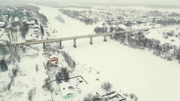 A Fabulous Snowcovered Landscape View of the Air a Bridge and a Frozen River