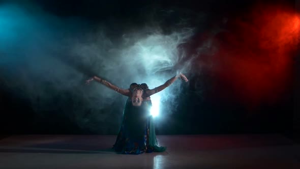 Beautiful Belly Dancer Girl Dancing Exotic Dance Movement on Black, Smoke, Back Light