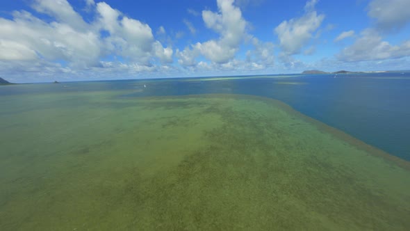 Coral Reef of the Pacific, Blue Green Sparkling Water Below and Fluffy Summer Clouds Above