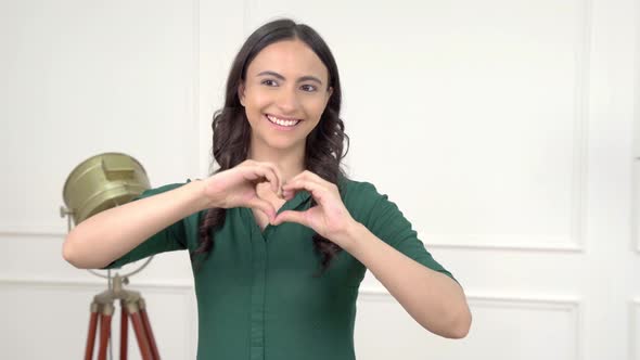 Indian woman showing heart sign