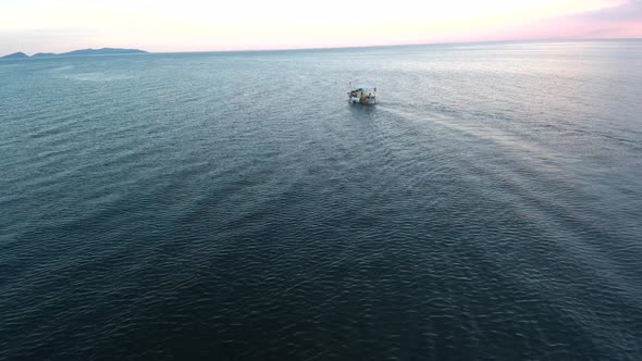 Fishing boat sailing into the sunset.