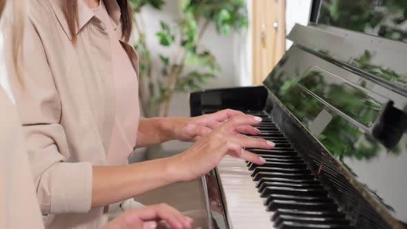 Mom And Daughter Playing Piano Together