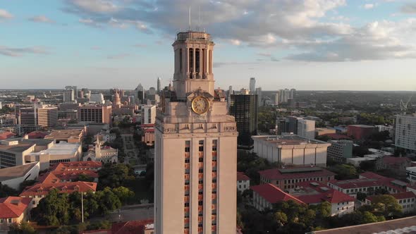 Orbit of the UT tower with lens flare. Shot at sunset revealing downtown Austin in the Background.