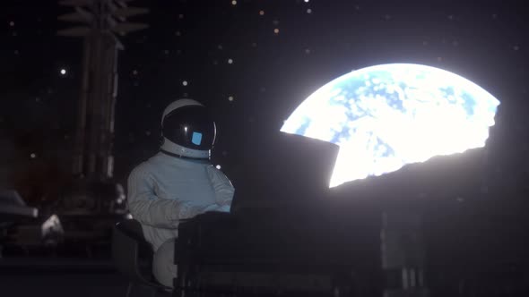 Astronaut Works on His Science Laptop in a Space Colony on One of the Planets
