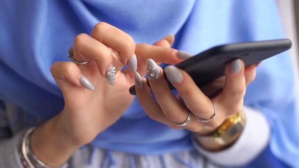 Close-up of Luxurious Hands of Young Muslim Woman Using Smartphone. Slow Motion