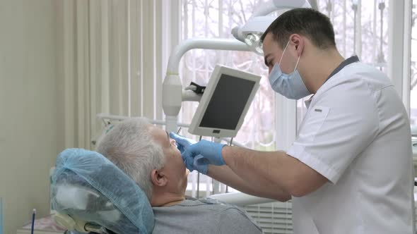 Senior Man Getting Treatment at Dental Office