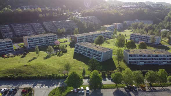 Modern design apartment buildings in family friendly green park area - Mornings sun aerial view - As