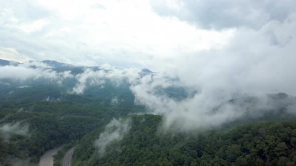 4K Drone Rise Up Through Clouds and Mountains