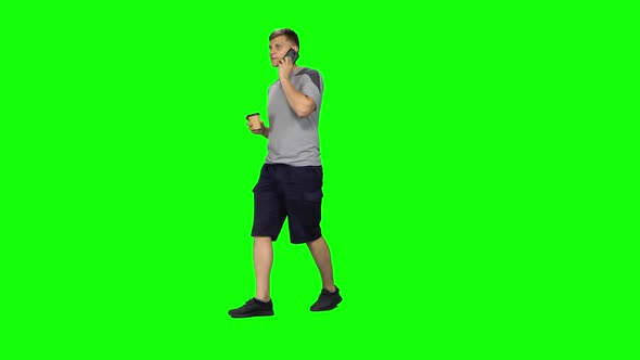 Young Male Walking Talking on the Phone and Drinking Coffee. Chroma Key