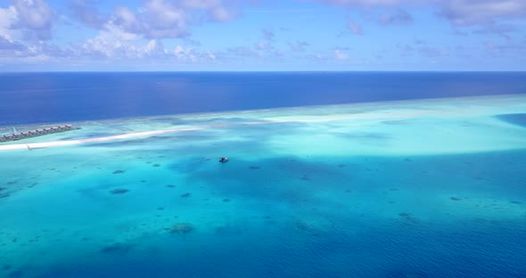 Wide birds eye clean view of a summer white paradise sand beach and turquoise sea background in vibr