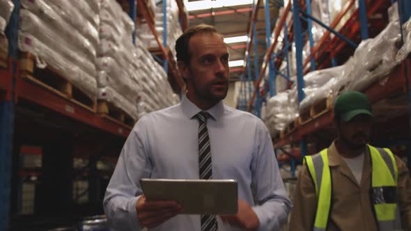 Male manager working in a warehouse 4k