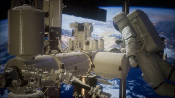 International Space Station and Astronaut in Outer Space Over the Planet Earth alt