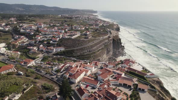 Azenhas do Mar town overlooking rocky Atlantic coast of Portugal. Waves washing on cliffs.