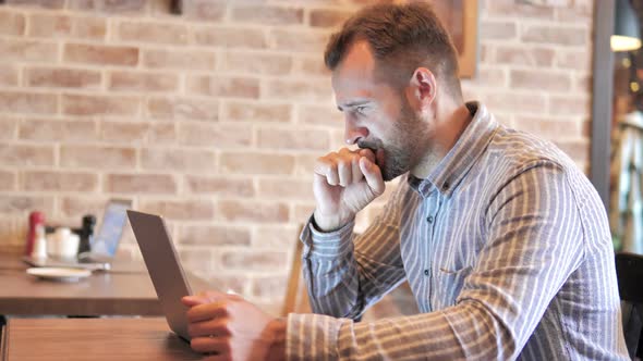 Man Frustrated by Results on Laptop in Loft Place