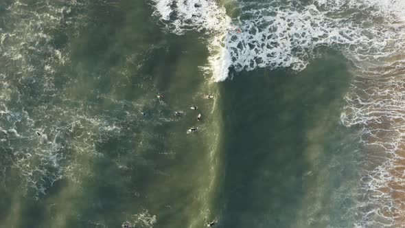 4k footage - Aerial / drone view of surfers waiting for the waves coming in. Surf can be a sport of