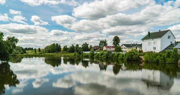 Village Landscape with a Small Lake, Time Lapse of Clouds Reflected in the Water, Beautiful Summer