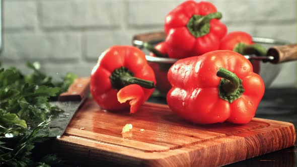 Pieces of Sweet Pepper Fall on the Cutting Board