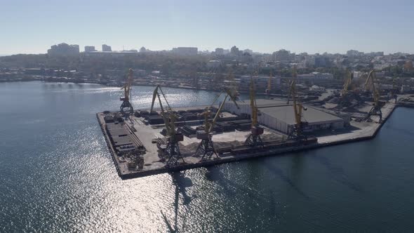 Top View of Trade Sea Pier with Containers and Lifting Cranes on Sea Quay Against City alt