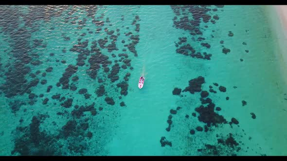 Aerial drone shot travel of relaxing island beach voyage by blue ocean with white sand background of