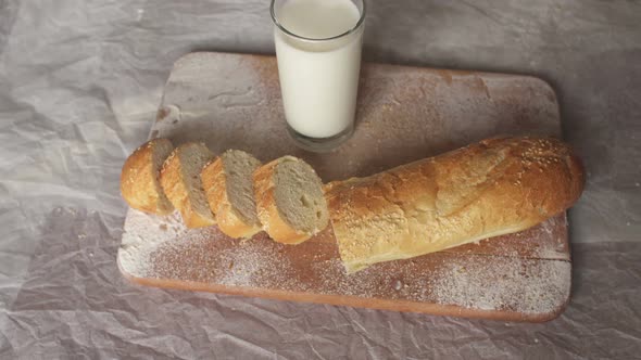 Sliced Baguette and a Glass of Milk Closeup