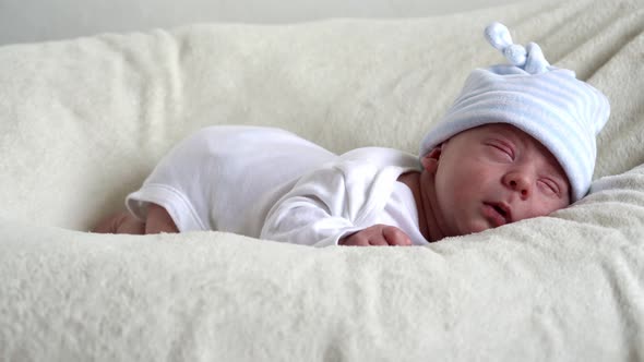 Closeup Newborn Baby Face Portrait Early Days Sleeping Sweetly On Tummy Beige White Background