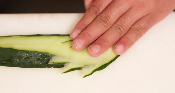 Slicing Fresh Cucumber With Style - Sushi Plate Decoration - close up, slow motion