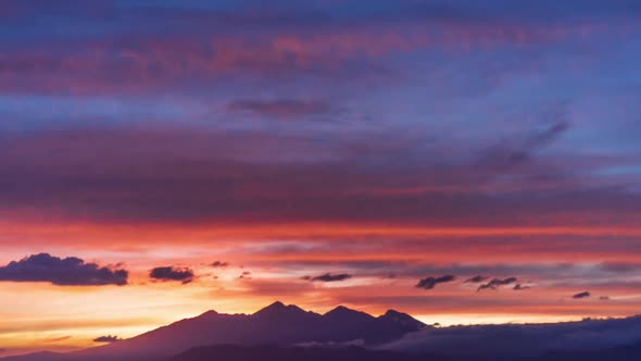 Bright Scenery Timelapse View on Red and Pink Sunset Colorful Cloudscape Above Peaceful Mountain