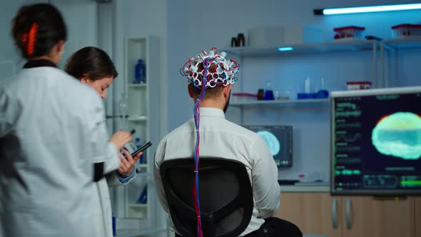 Back View of Man Wearing Performant Brainwave Scanning Headset