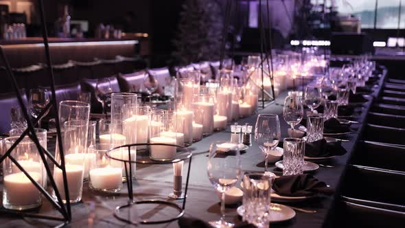 Elegant Table Set with Glasses Lighted Candles