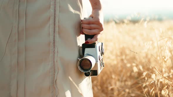 8Mm Cinema Film Camera Hand Held By a Girl in the Countryside