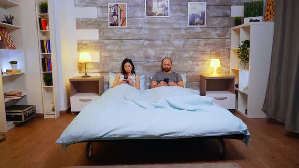 Zoom in Shot of Couple Laying in Comfortable Bed