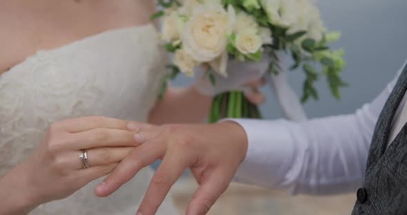 Closeup Hands of the bride and groom during an exchange of rings at a wedding ceremony