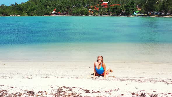 Beautiful happy ladies travelling in the sun at the beach on paradise white sand and blue background