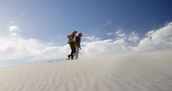 Couple walking in the desert 