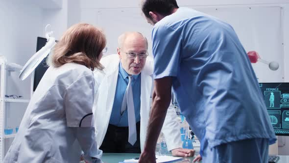 Team of Scientists and an Assistant Are Talking alt