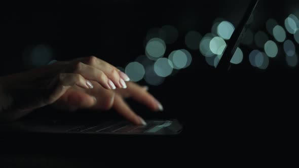 Female Hands Is Typing on a Laptop at Night