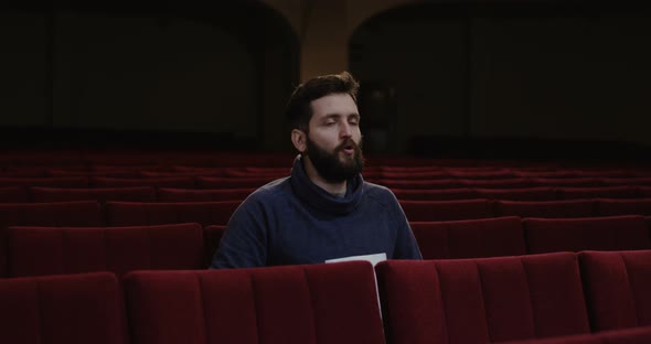 Man Watching a Theater Performance Alone