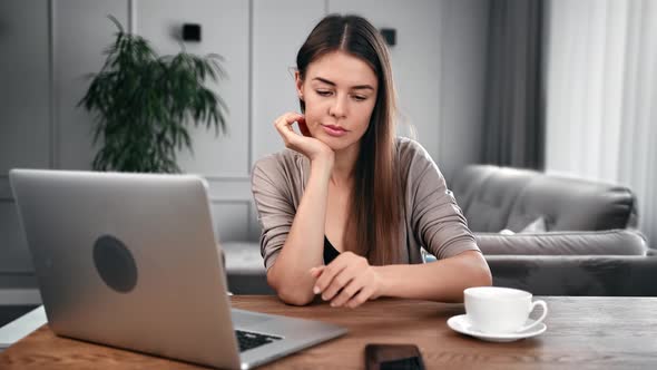 Annoyed Woman Read Bad News Message on Smartphone Sitting at Desk