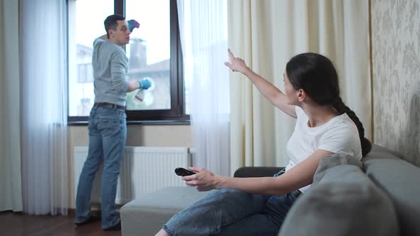 Husband Washes the Window and Wife Watches Tv