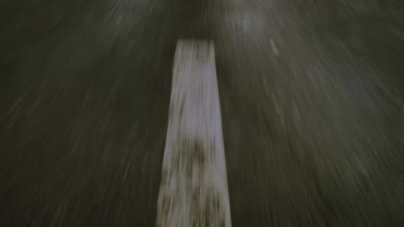 Closeup Cinematic POV Shot of an Wet Asphalt Road