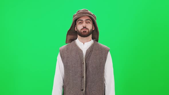 Portrait of a Man of Arab Appearance in Traditional Clothes a Man on the Background of a Chromakey