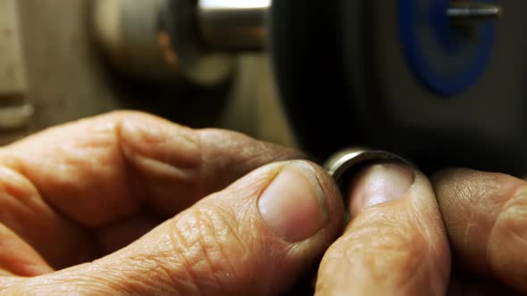 Goldsmith polishing ring in workshop 4k