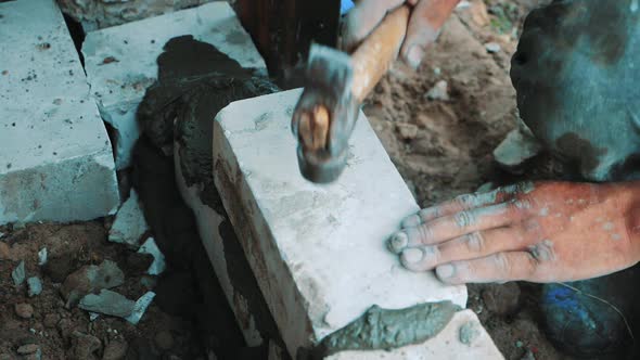 Construction Worker or Mason Laying Bricks and Creating Walls. Bricklayer Laying Bricks To Make a